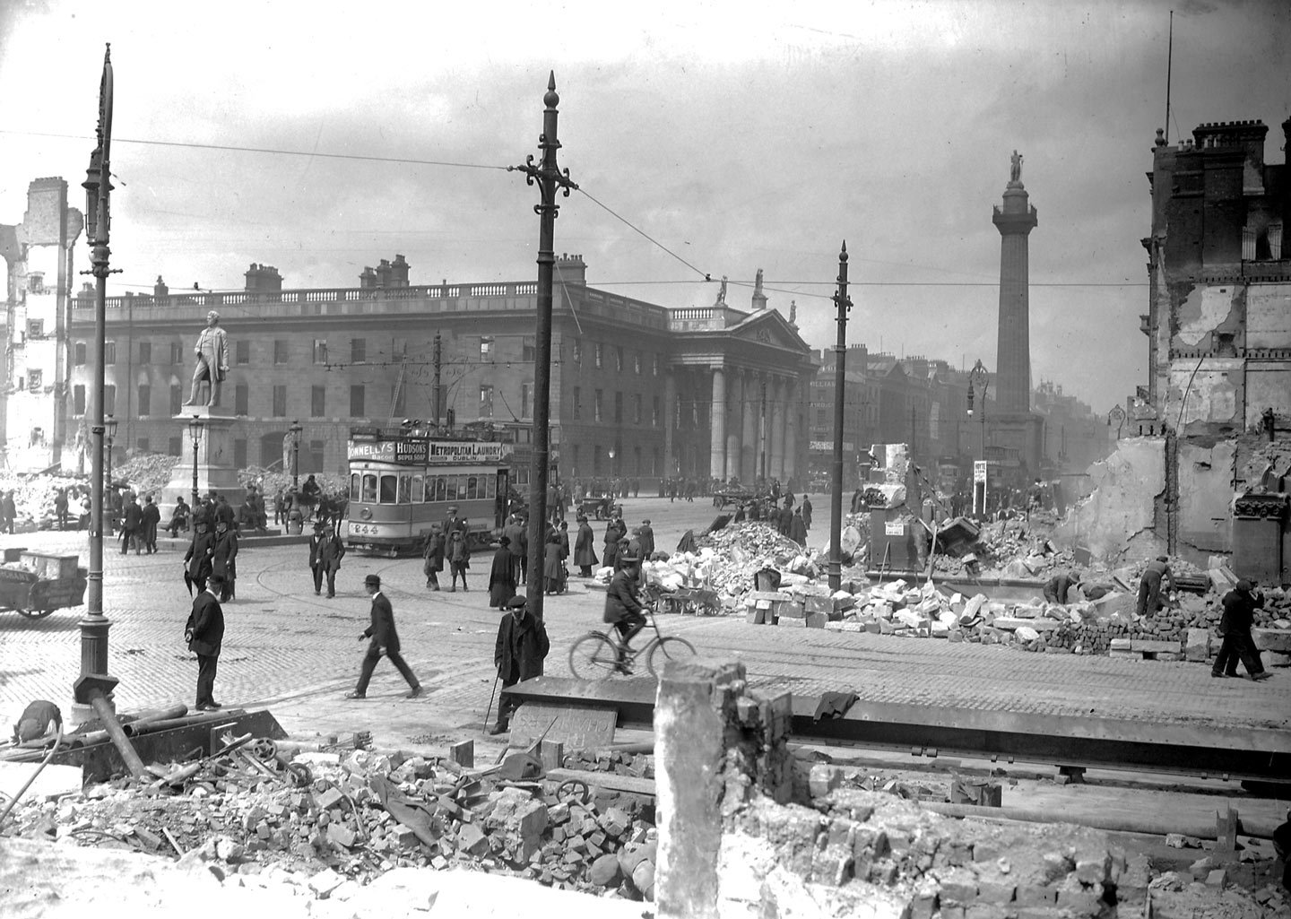 Crowds in Sackville Street (now O'Connell Street) can be seen next to the General Post Office showing damage from shelling following the Easter Uprising [bbc.com]