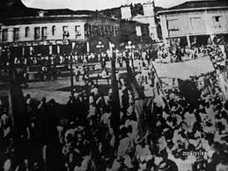 A crowd of striking workers in the street, some carrying banners