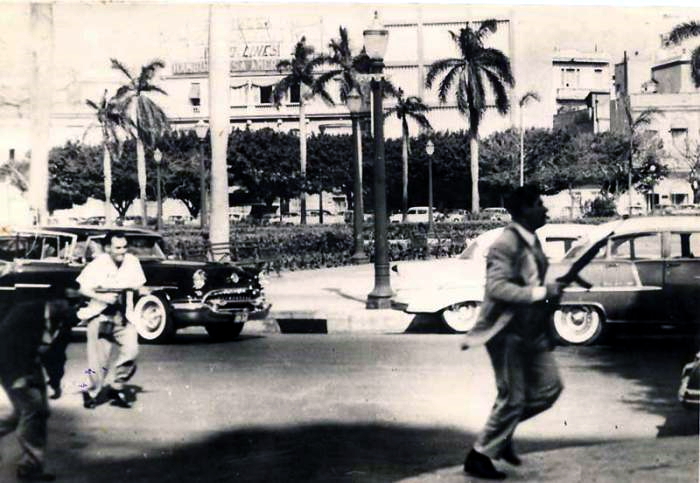 Two men, armed with rifles, participating in the palace attack in Havana on March 13th, 1957