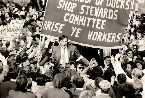 A workers' rally with a sign saying "ROYAL GROUP OF DOCKS SHOP STEWARDS COMMITTEE ARISE YE WORKERS" [socialist.net]