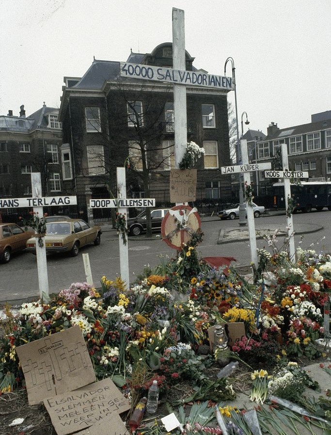 A memorial for those killed during the Salvadoran Civil War, located at the Museumplein in Amsterdam. Five crosses have been placed - four for the killed Dutch journalists in El Salvador, and a central, elevated one for 40,000 murdered Salvadorans. [Wikipedia]