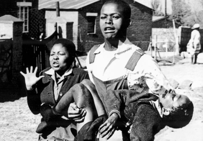Antoinette Sithole and Mbuyisa Makhubo carrying and 12-year-old Hector Pieterson moments after he was shot by South African police during a peaceful student demonstration in Soweto, South Africa. Photo by Sam Nzima. [Wikipedia]