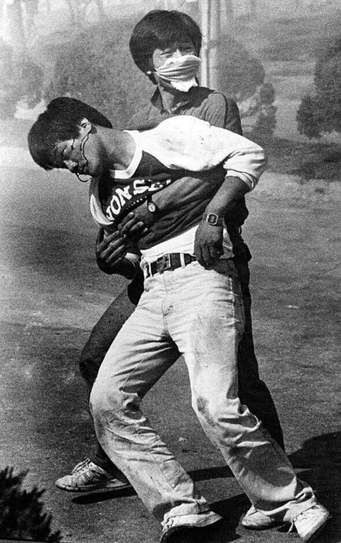 Photograph taken outside of Yonsei University after Lee was hit in the back of the head with a tear gas canister; this image is associated with democracy in South Korea (Copyright: Tony Jeong)