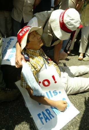 Korean farmer Lee Kyung-hae collapsed after stabbing himself in the chest during the anti-WTO protest
